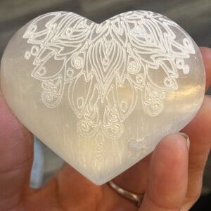 Peacock feather engraved selenite heart palmstone